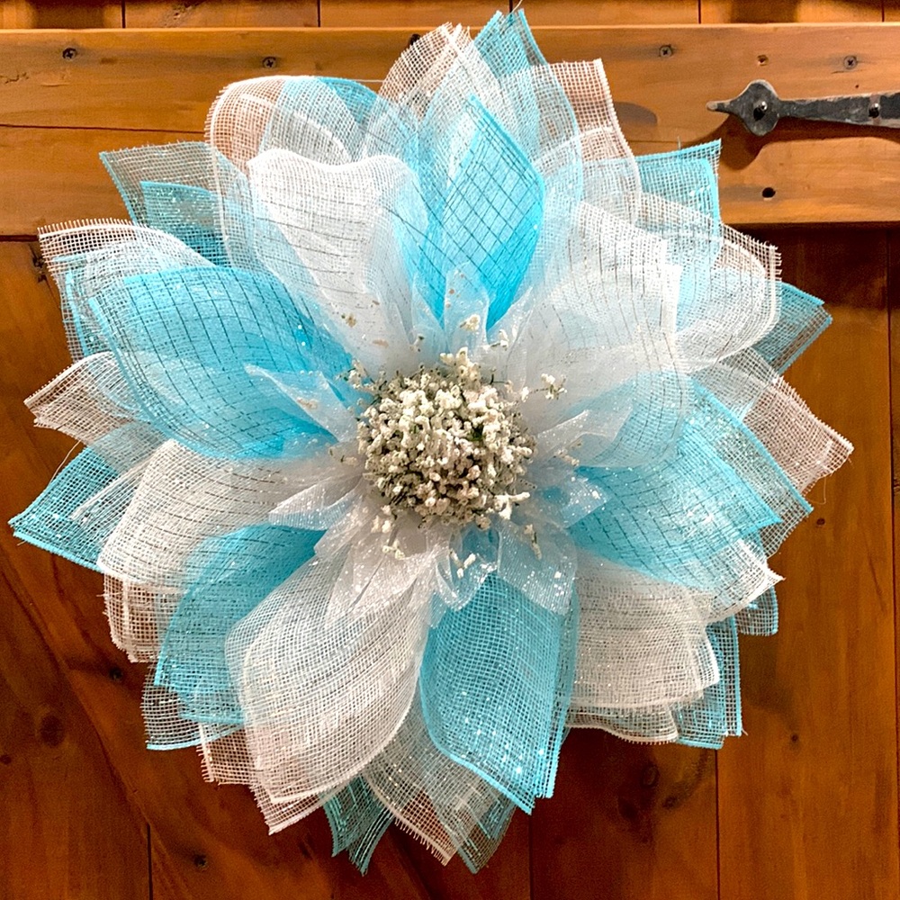 This is a light blue and white deco mesh flower wreath